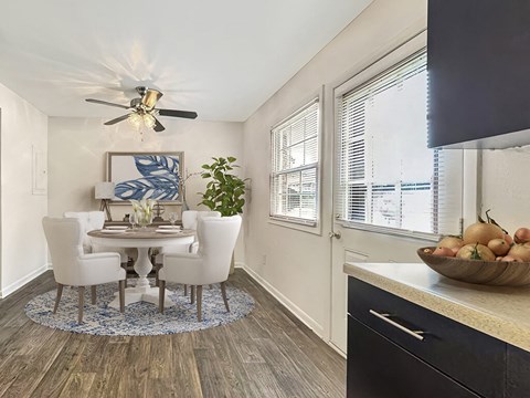 a dining room with a table and chairs and a ceiling fan