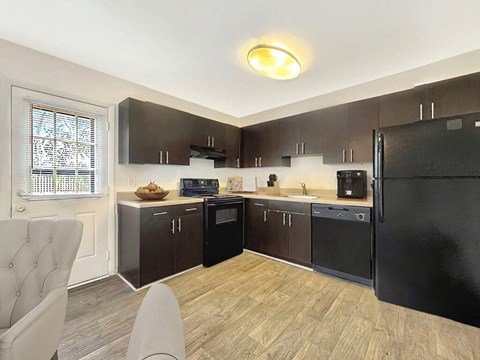 a kitchen with black appliances and a black refrigerator
