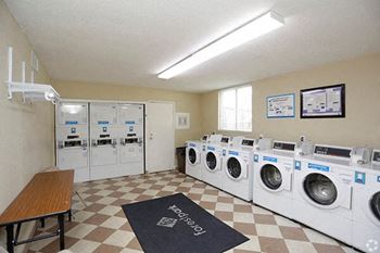 a laundry room with a bunch of washing machines