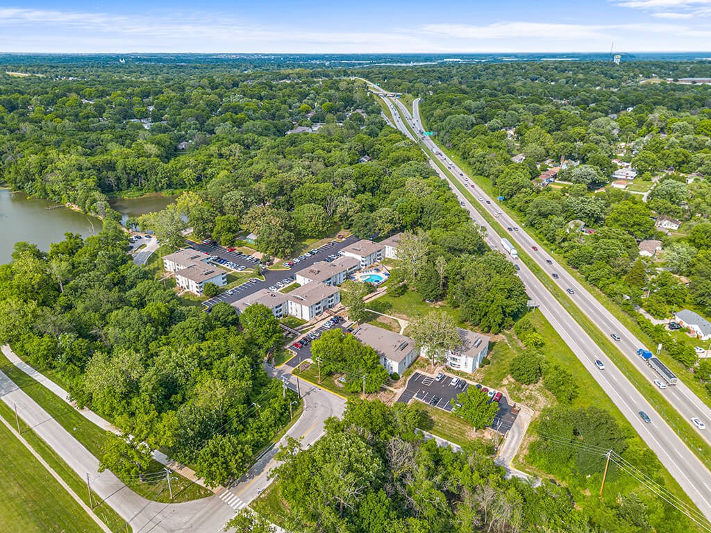 a aerial view of apartment community and a highway