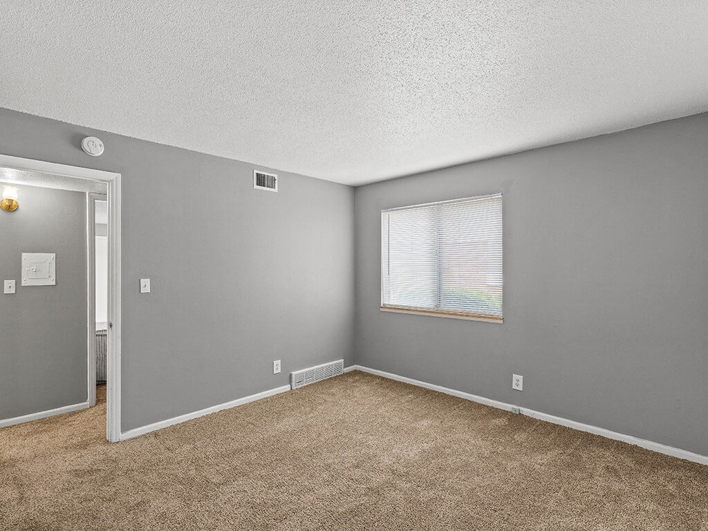 bedroom with a window and carpet