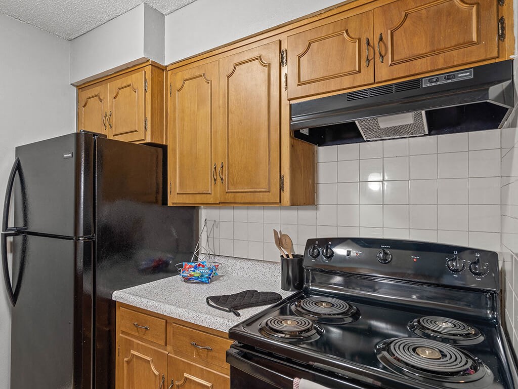 a kitchen with a stove and a refrigerator