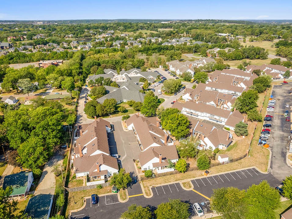 an aerial view of a neighborhood with houses and trees