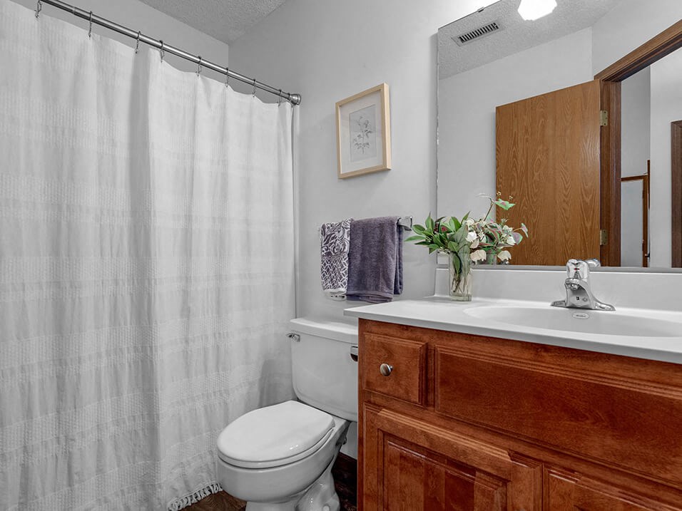 a bathroom with a toilet and a sink and a shower