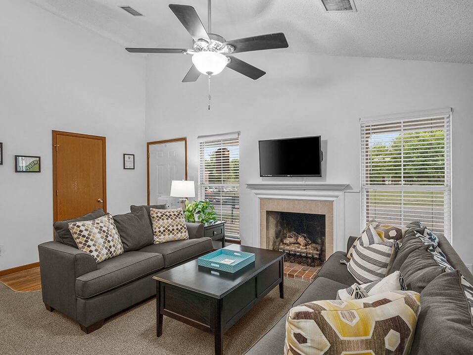 a living room with two couches and a fireplace