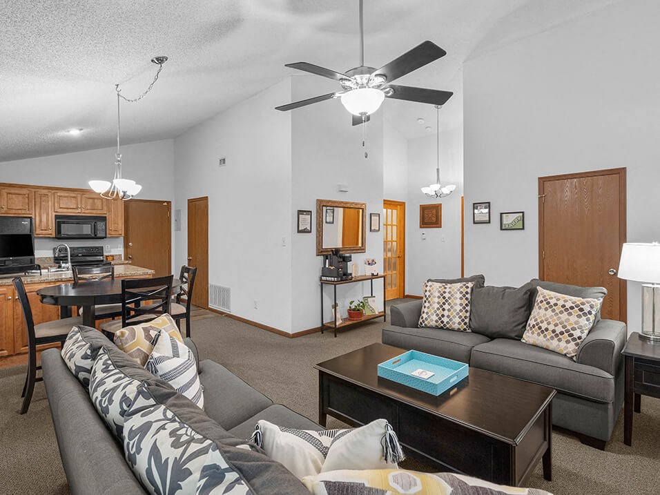 a living room and kitchen with a couch and a table