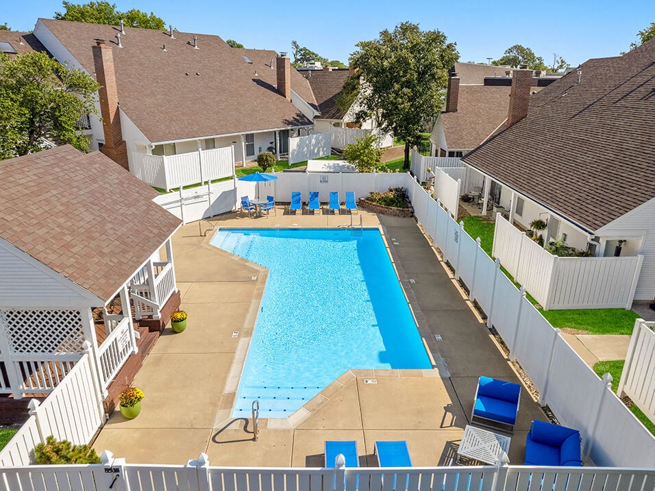 an aerial view of a large swimming pool surrounded by houses