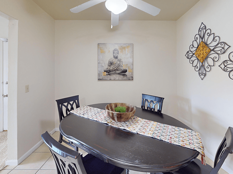 A dining room with a table set for two.