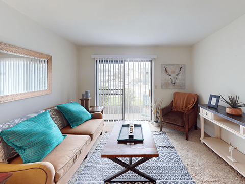 A living room with a couch, chair, and coffee table.