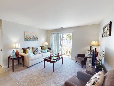 A living room with a couch, chairs, and a coffee table.