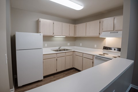 A kitchen with white appliances and cabinets.
