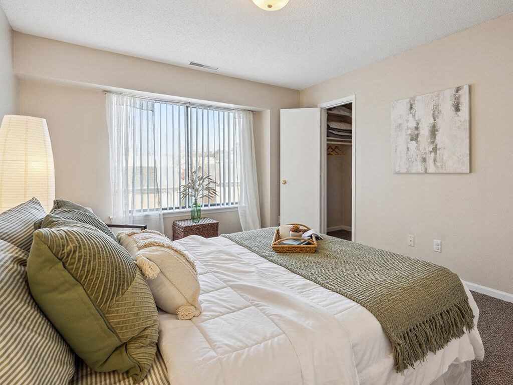 primary bedroom with a bed and a window