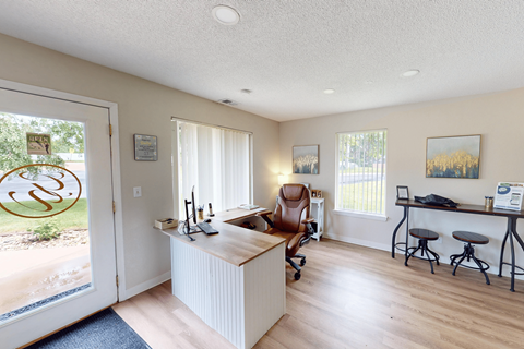 A kitchen with a white counter and a brown chair.