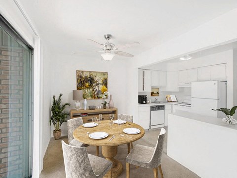 a kitchen and dining room with a table and chairs