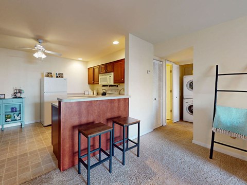 a kitchen with a counter and three stools