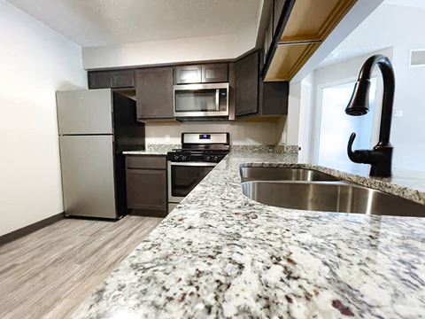 hully equipped kitchen with granite coutnertops at huntington glen