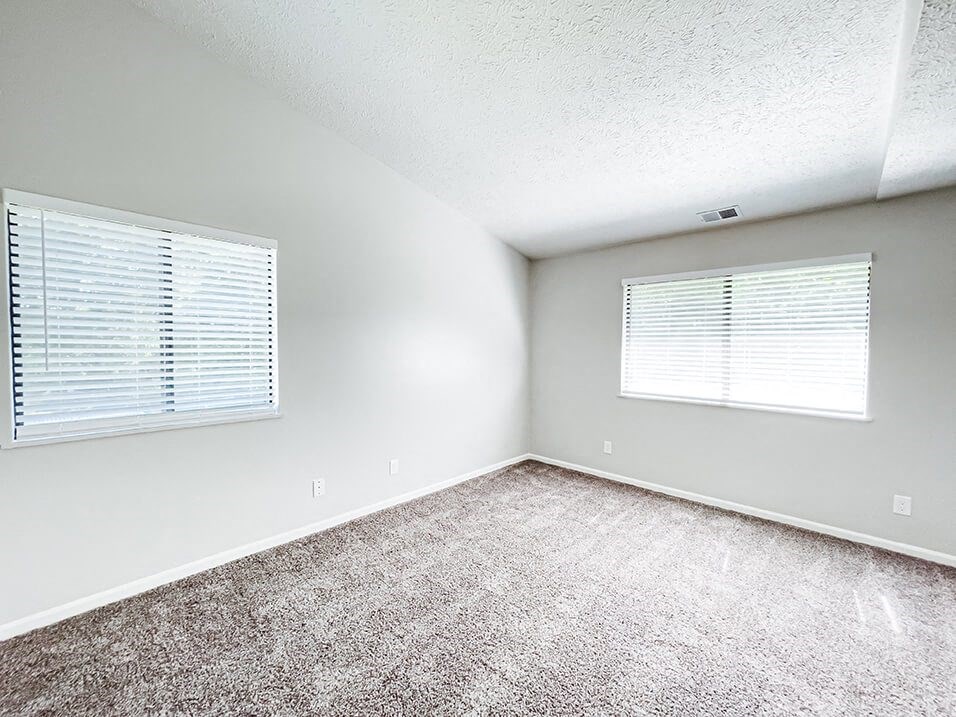 bedroom with two windows at huntington glen apartments