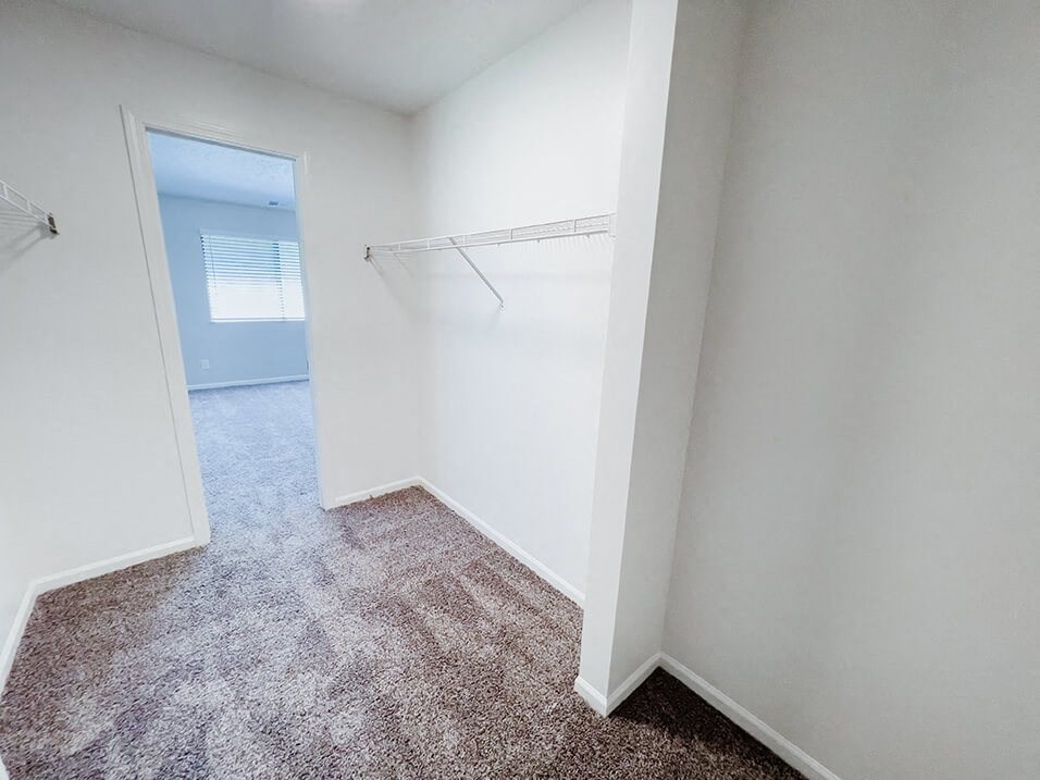 walk-in closet attached to bedroom