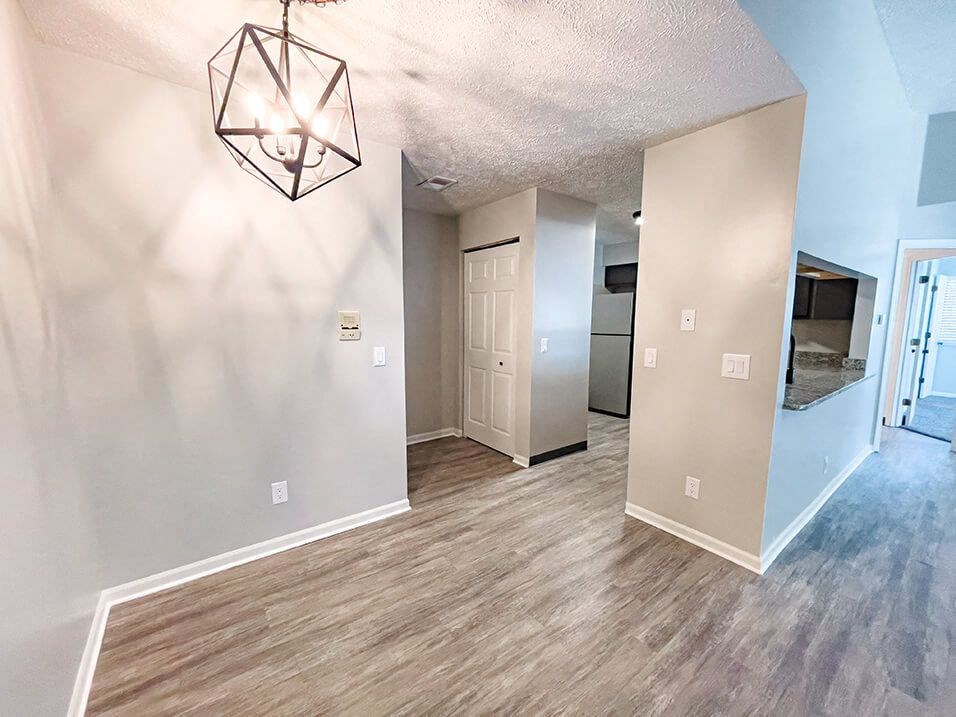 dining room with connected kitchen and hardwood style flooring