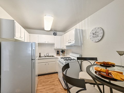a kitchen with a dining table and a refrigerator