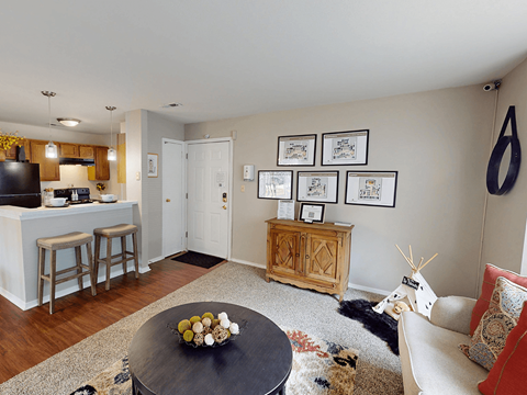A modern kitchen with a black countertop and white cabinets.