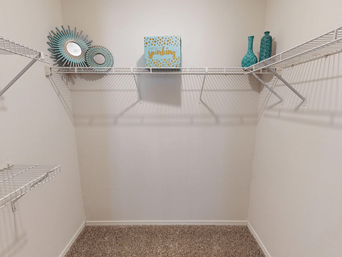A white shelf with a few decorative items on it.