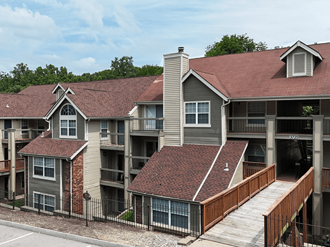 Apartment complex with a mix of brick and siding exteriors.