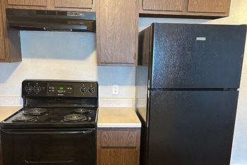 a kitchen with a stove and a refrigerator