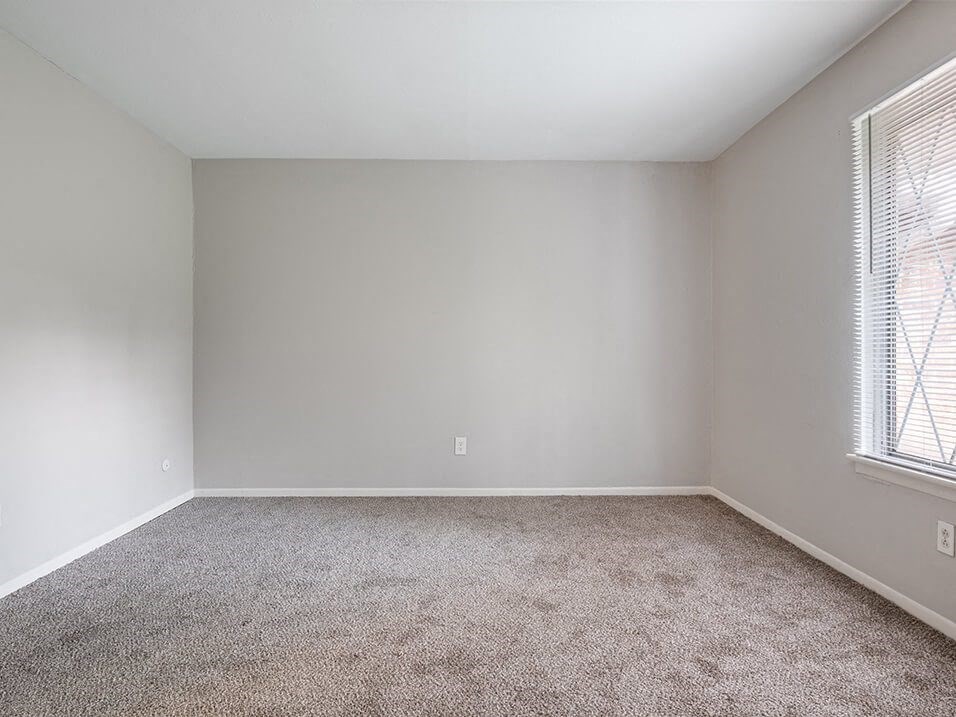 bedroom with a carpeted floor and a window