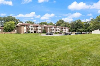 a large lawn in front of an apartment building