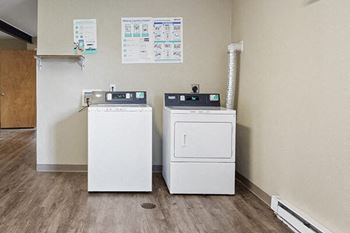 two washing machines in the corner of a room