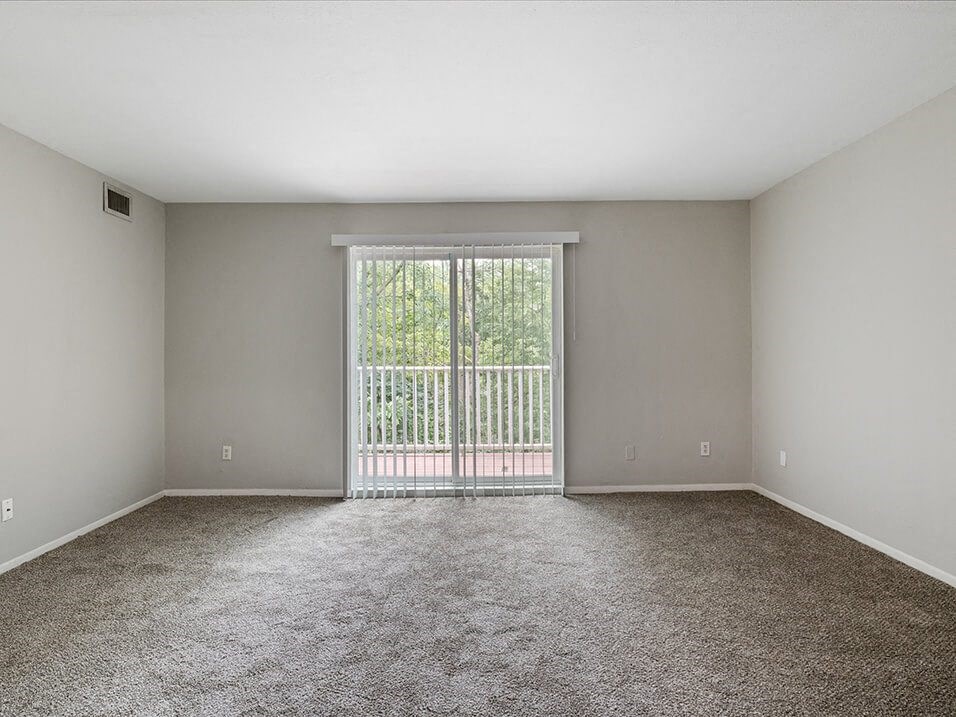 apartment living room with a sliding glass door to a balcony