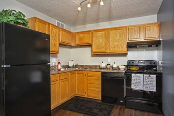 spacious kitchen with black appliances at indian woods apartments