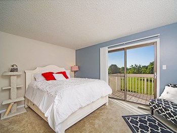 Primary bedroom with Attached Balcony at Indian Woods Apartments in Evansville - Photo Gallery 3
