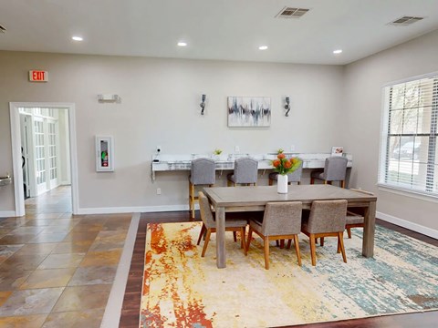 A dining room with a table set for four.
