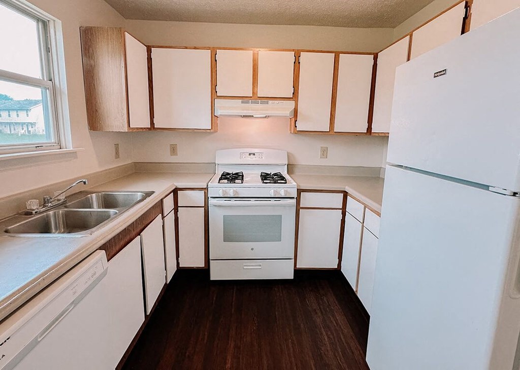 a kitchen with a stove and a refrigerator
