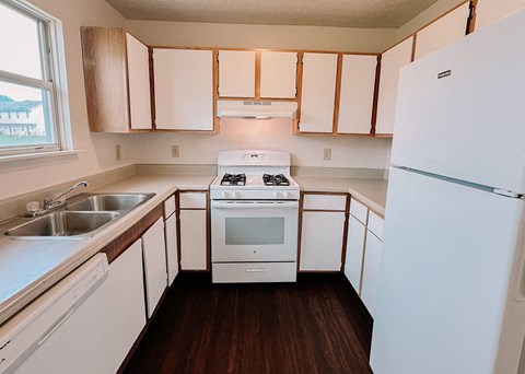 a kitchen with a stove and a refrigerator