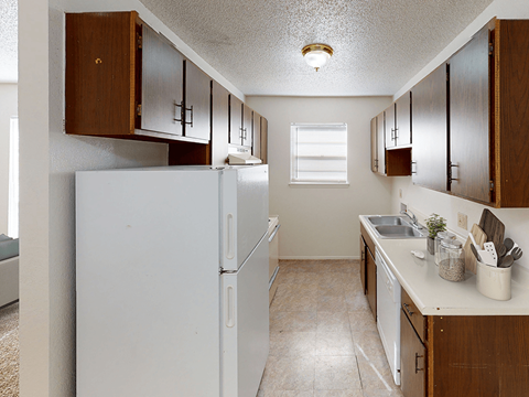 a kitchen with white appliances and wooden cabinets