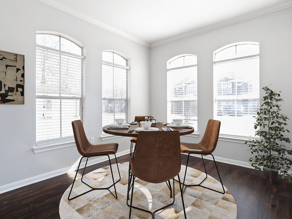 a dining room with big windows