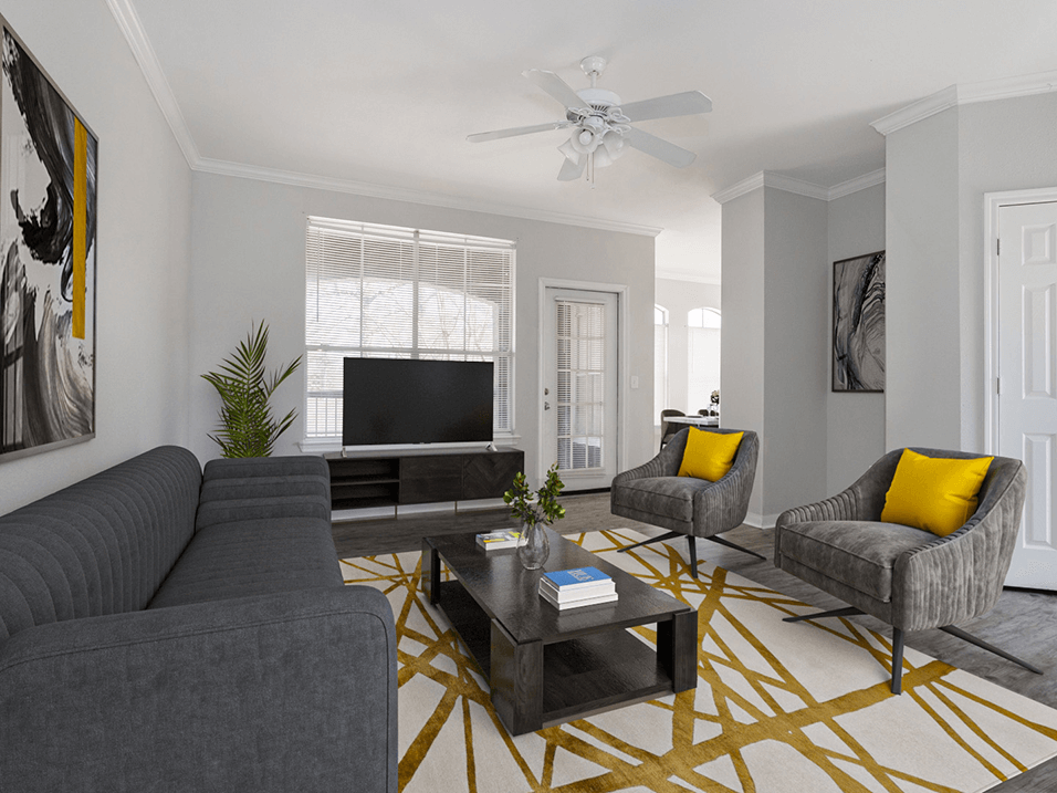 a living room with gray walls and a yellow and gray rug