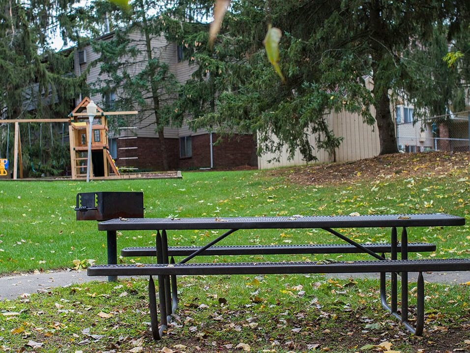 a park bench in front of a playground