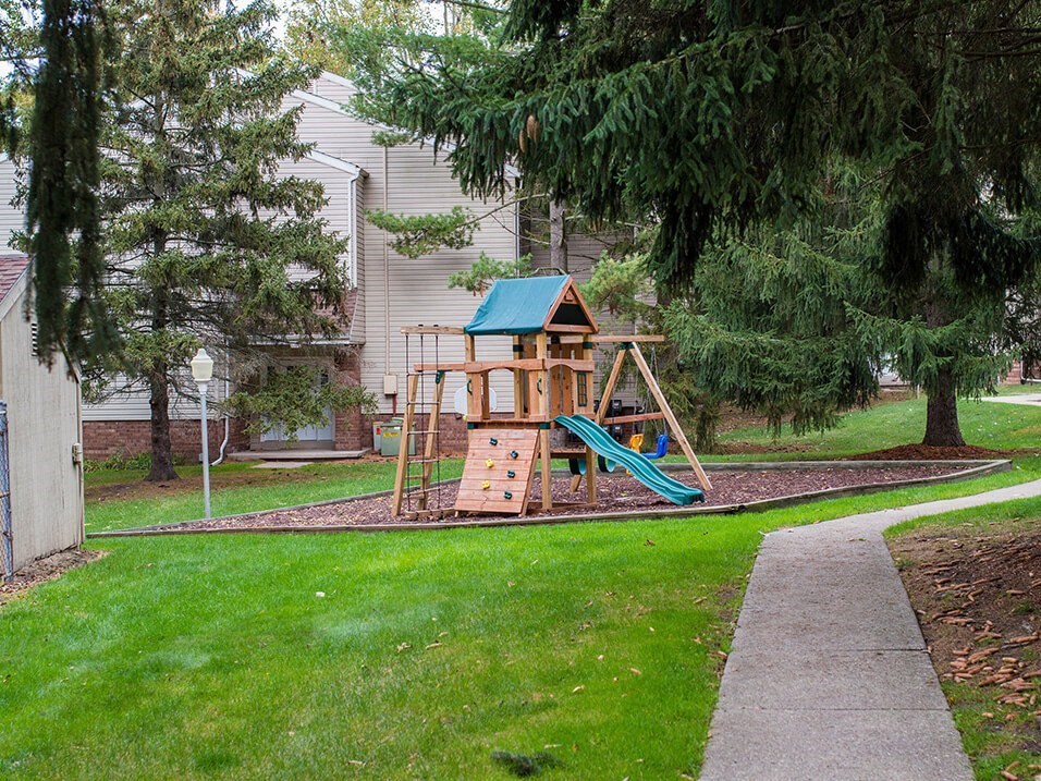 a swing set in the backyard of a house