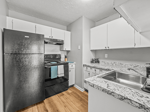 a kitchen with stainless steel appliances and white cabinets