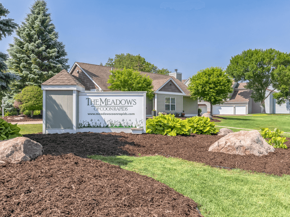 a home with a sign in front of it that says the meadows of commerce