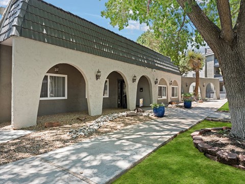 a building with a black roof and a courtyard