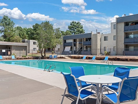 our apartments offer a swimming pool with chairs and a table