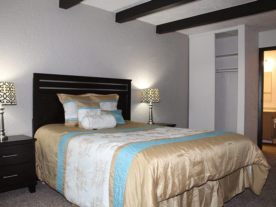 a bedroom with a bed and two nightstands