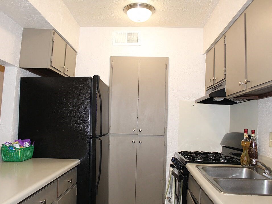 a kitchen with a refrigerator sink and stove