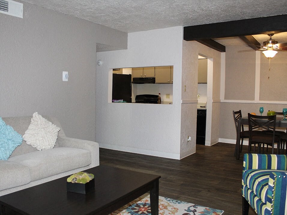 a living room with a couch a table and a chair