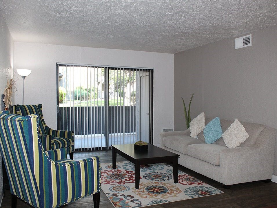 a living room with a couch and two chairs